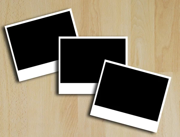 Photo frames on wood floor — Stock Photo, Image