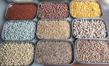 Indian pulses and cereals on display in a shop at bangalore market clipart