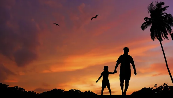 Silhouette of father and son walking together — Stock Photo, Image