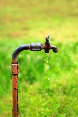 Old rusty tap with water leaking clipart