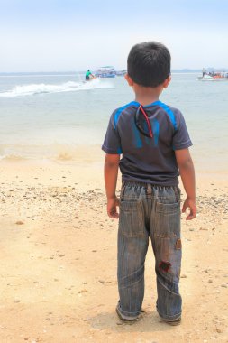 Young kid standing and watching bike adventure clipart