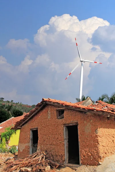 stock image Old mud house in rural india with wind mill