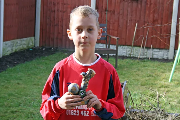 Teenage boy with football award — Stock Photo, Image