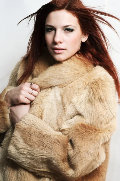 Sexy redhead young girl in a fur coat — Stock Photo, Image