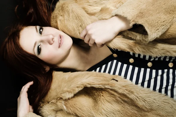Sexy redhead young girl in a fur coat — Stock Photo, Image