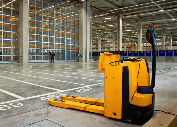 Electric forklift in storehouse — Stock Photo, Image