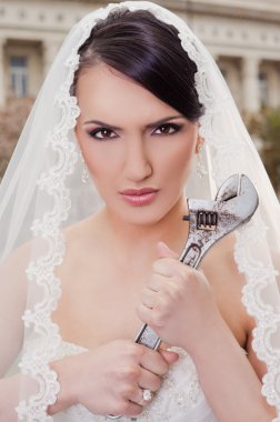 Angry bride hodling wrench clipart