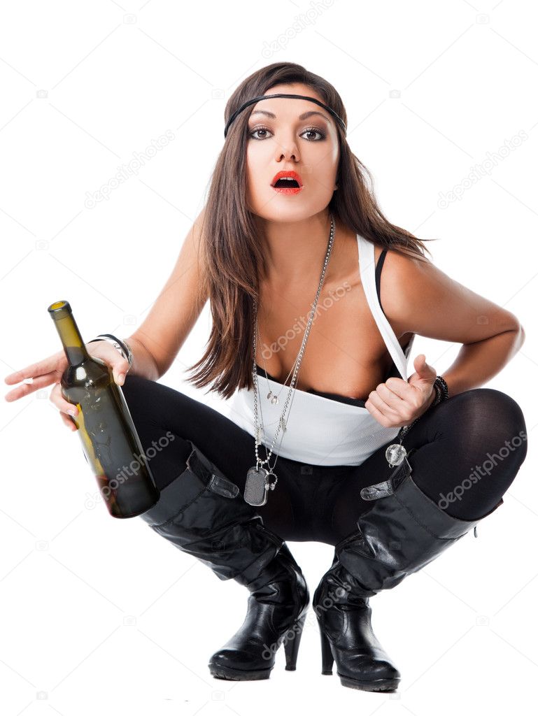 Sexy prostitute crouching holding bottle
