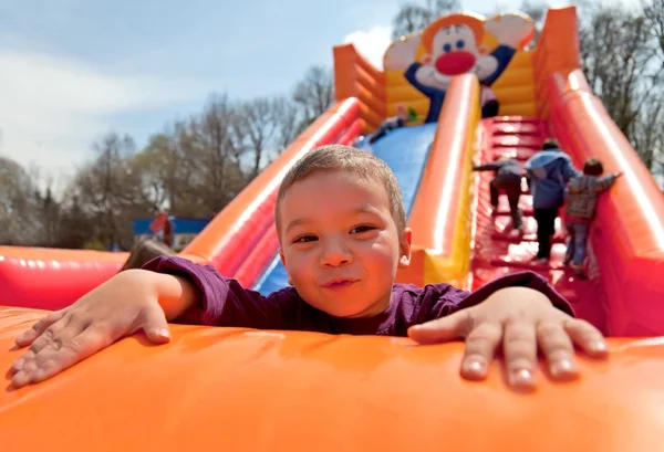 Boy inflatable slide — Stock Photo, Image