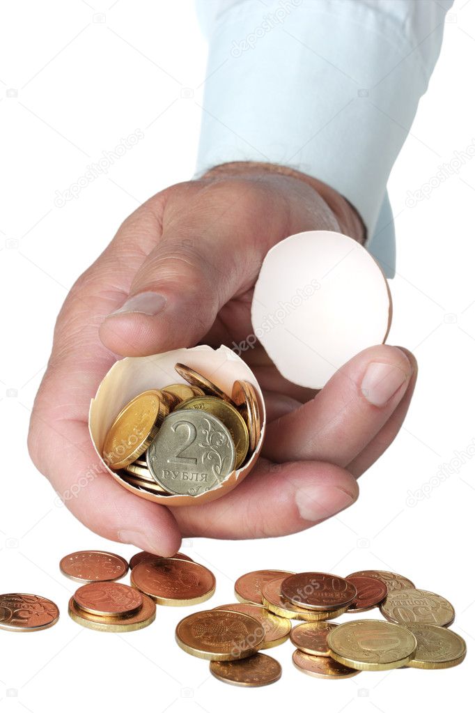 Coins in broken eggshell, in hand