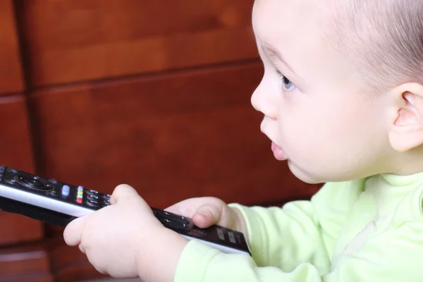 stock image Little child with a TV remote control