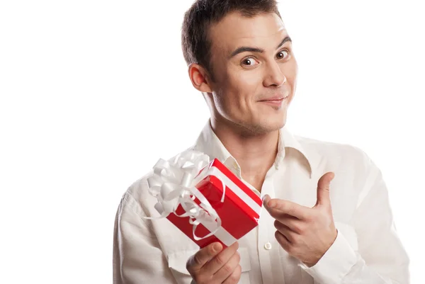 Smiling man pointing on gift isolated — Stock Photo, Image