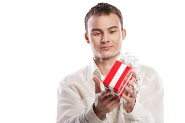 Smiling man holding gift isolated on white — Stock Photo, Image