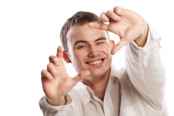 Young man making frame with finger on white — Stock Photo, Image