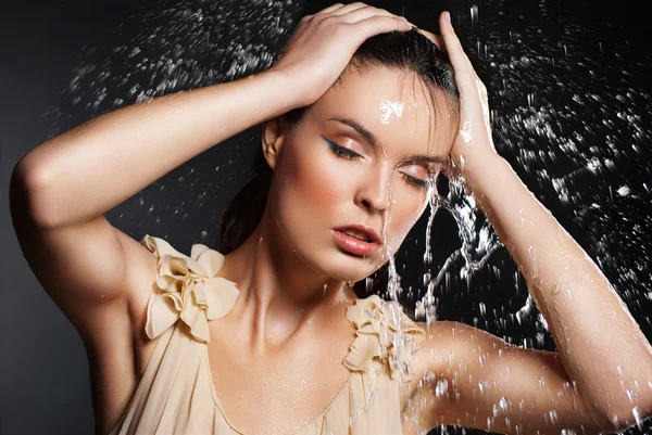 Young beautiful woman under the stream of water — Stock Photo, Image