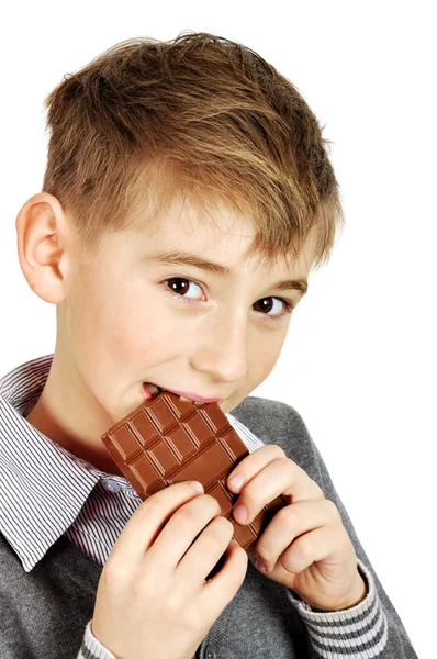 Dreng spiser en chokolade bar - Stock-foto