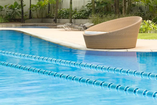 Kristall-Klappschwimmbecken mit rundem, gemütlichem Stuhl an der Seite — Stockfoto