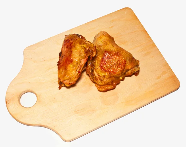 stock image The fried pieces of chicken on a chopping board on a white backg