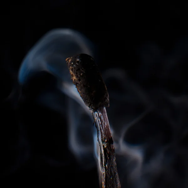 Burning match on a black background — Stock Photo, Image