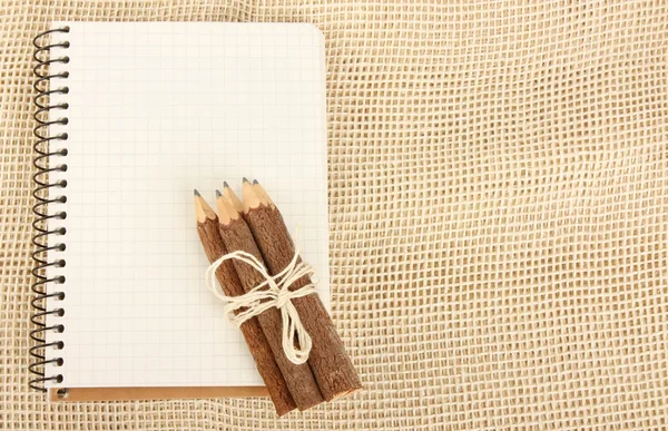 stock image Notebook and pencils on burlap