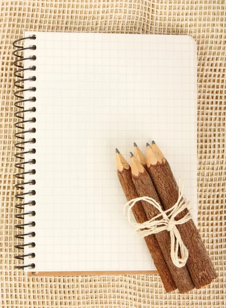 Ноутбук и карандаши на мешковине — стоковое фото