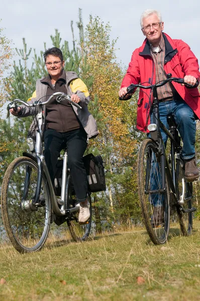 Seniors on a bike — Stock Photo, Image