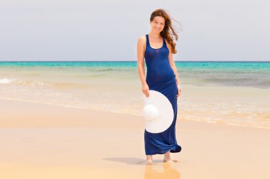 Young woman on the ocean beach clipart