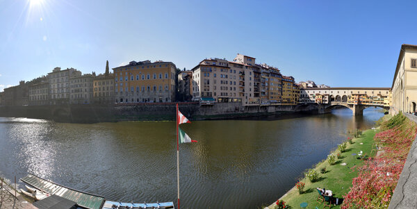 Relax in Florence in a sunny day in front of famous Ponte Vecchio on Arno river