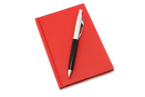 Bloc de notas rojo con bolígrafo — Foto de Stock