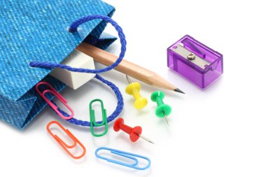 Stationery items poured out from shopping bag clipart