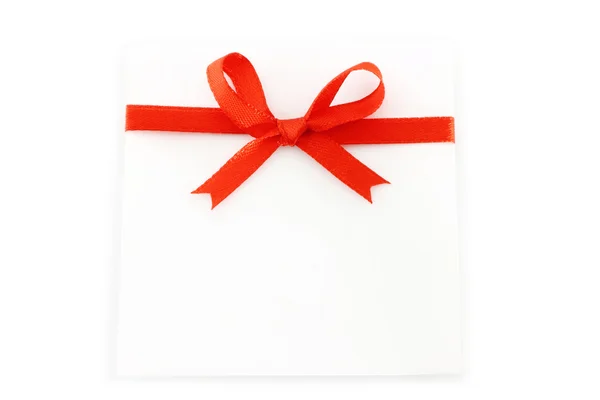 Sheet with red holiday bow — Stock Photo, Image