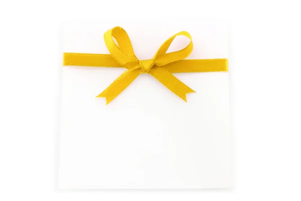 Sheet with yellow holiday bow — Stock Photo, Image