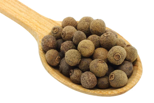 Seeds of allspice in wooden spoon — Stock Photo, Image