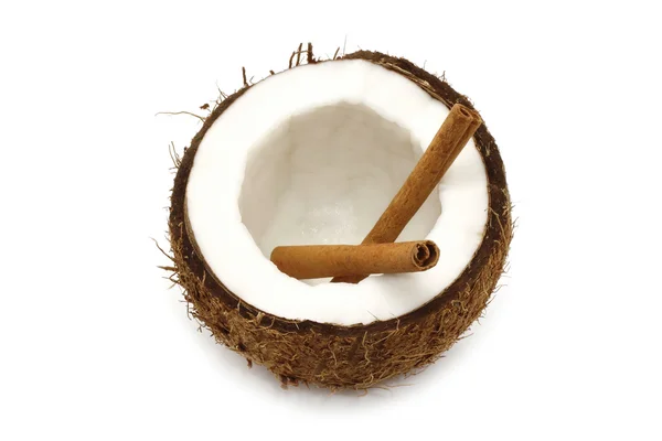 Fresh coconut with cinnamon sticks — Stock Photo, Image