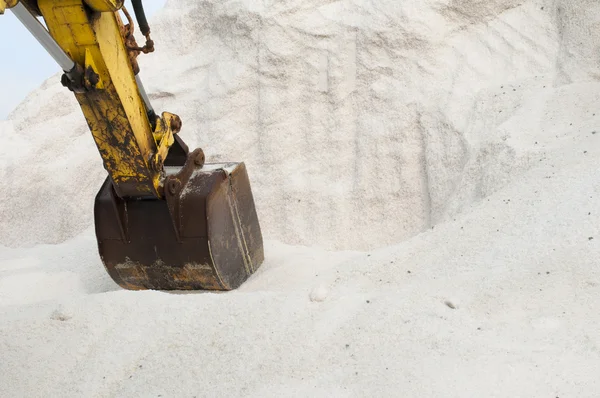 Excavator digging pile salt — Stock Photo, Image
