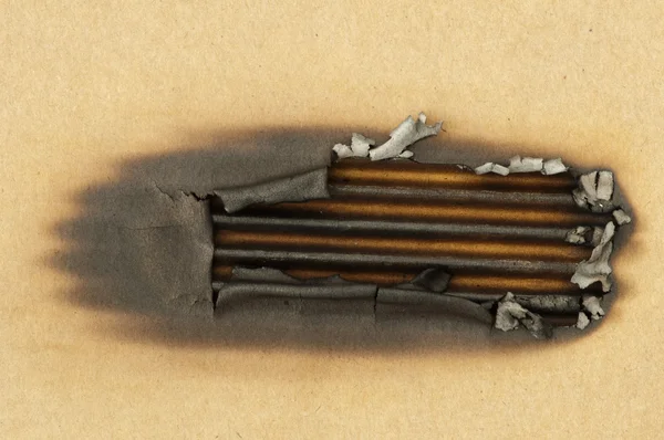 Burned paper and hole — Stock Photo, Image