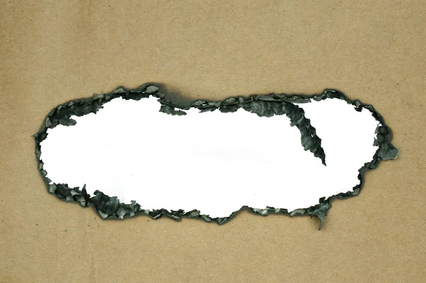 Yanmış kağıt ve delik — Stok fotoğraf
