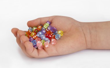 Children hand holding cubes with letters clipart