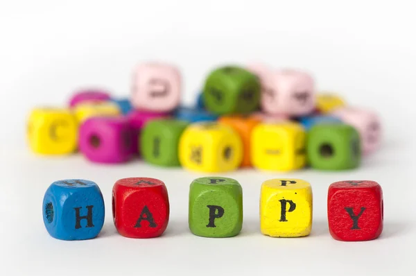 Text šťastný barevné kostky — Stock fotografie