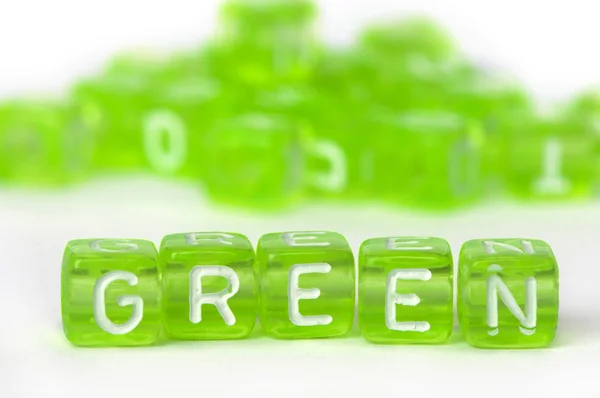 Text grün auf bunten Würfeln — Stockfoto