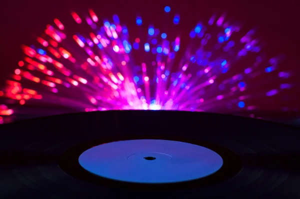 LP vinyl record and disco lights — Stock Photo, Image