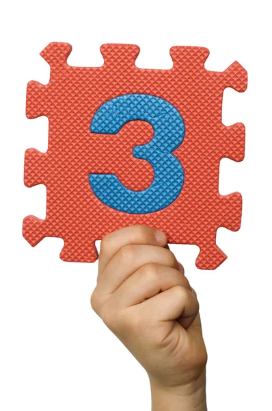 Children hand holding the number Three. White isolated number — Stock Photo, Image