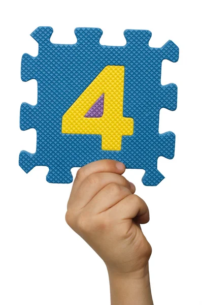 Children hand holding the number Four. White isolated number — Stock Photo, Image
