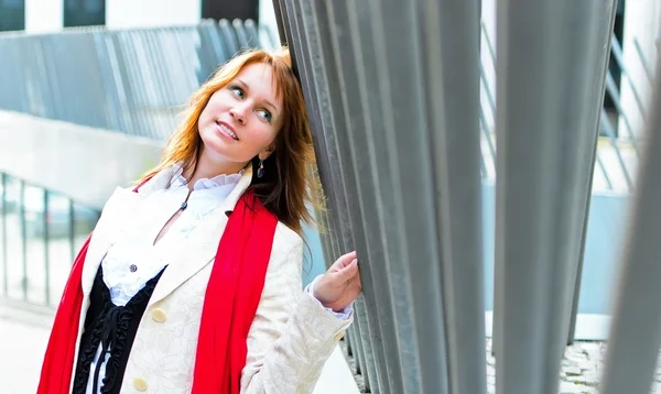 Portrait of pretty girl next to a steel fence — Stock Photo, Image