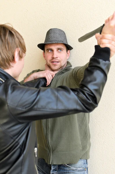 Burglar is trying to kill man by knife. — Stock Photo, Image