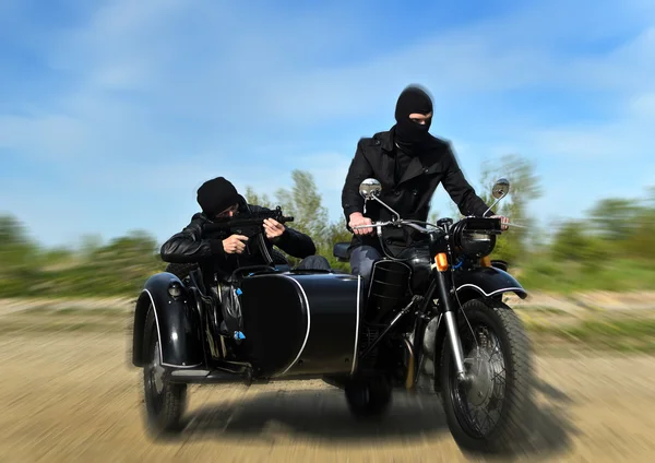 Two armed men riding a motorcycle with a sidecar. Motion blur. — Stock Photo, Image