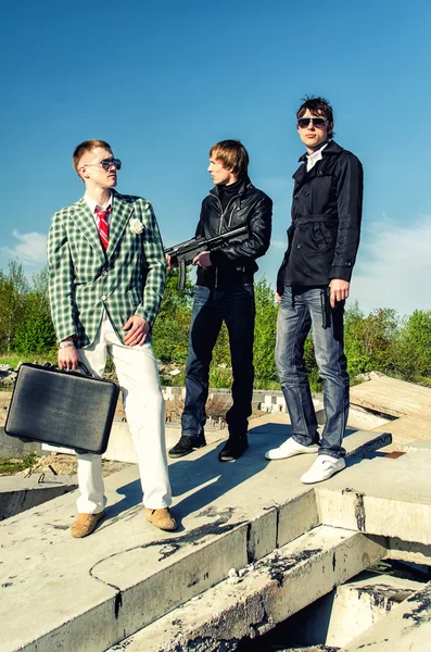 Mafia: Three thugs with a suitcase and weapons — Stock Photo, Image