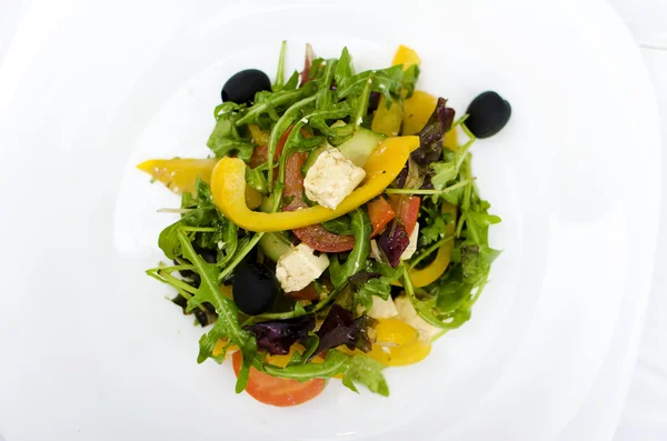Fresh Greek salad on white plate — Stock Photo, Image