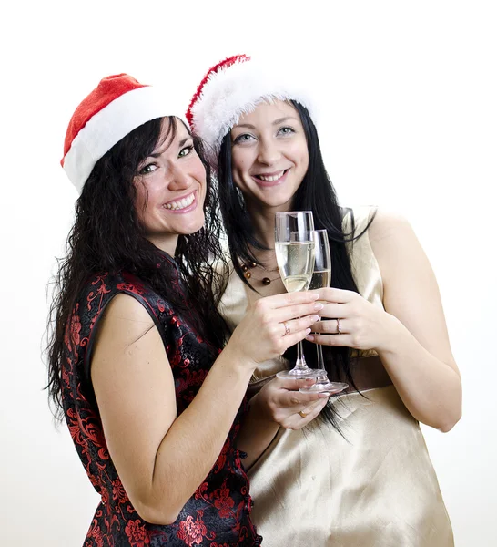 Natal: duas meninas de chapéu vermelho se divertir — Fotografia de Stock