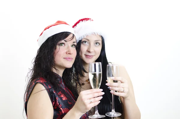 Christmas: two girls in red hat have fun — Stock Photo, Image